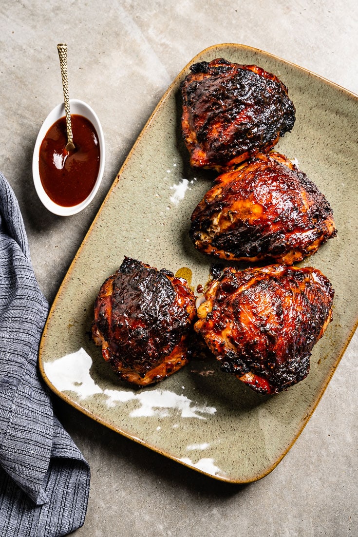 BBQ Chicken Thighs with sauce on platter