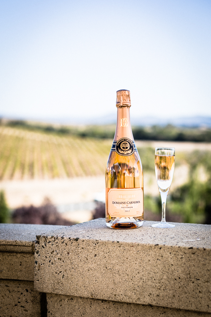 Domaine Carneros napa brut rose with vinyard in background