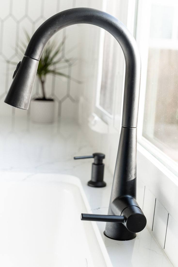 Moen Sleek MotionSense Matte Black faucet with white sink