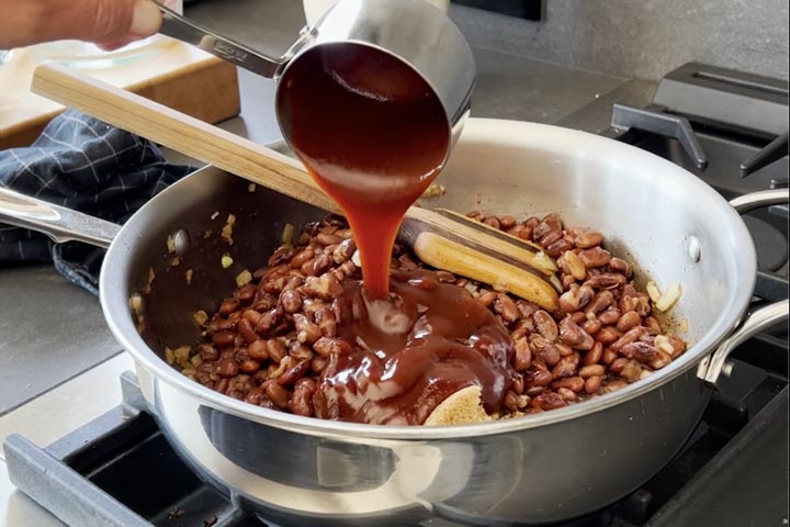 adding ingredients for smoked baked breans