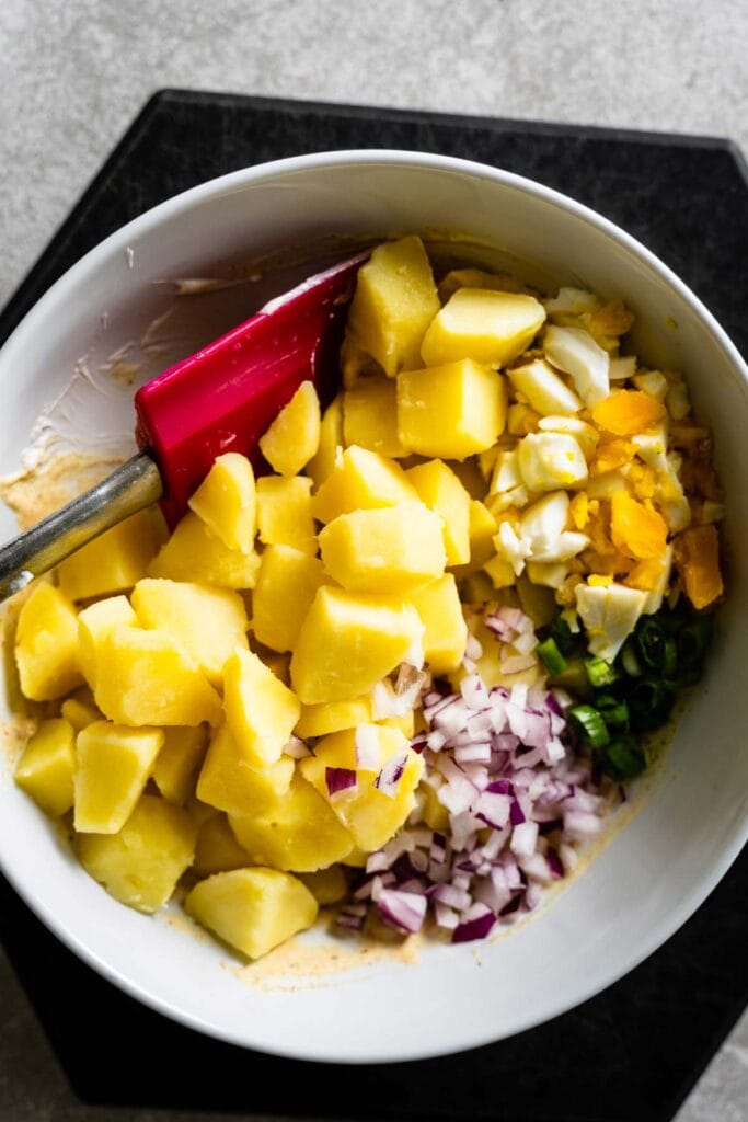 american potato salad ingredients in bowl