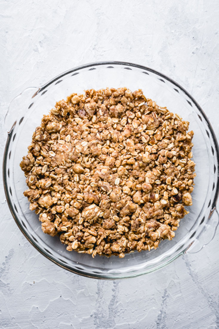 apple crisp crumble in bottom of pie dish