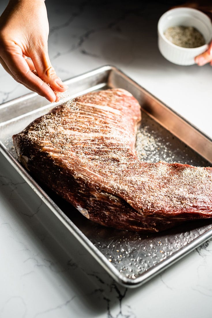 applying seasoning to tri tip