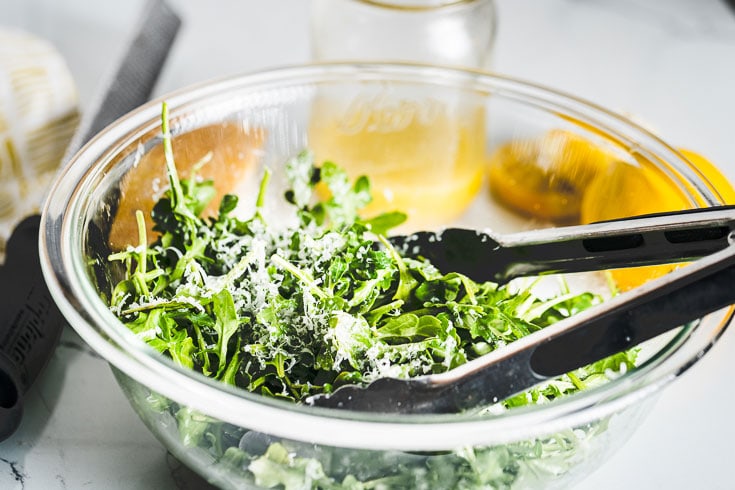 arugula salad with lemon vinaigrette in bowl