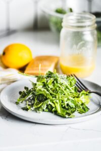 arugula salad with lemon vinaigrette on plate vertical