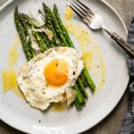 asparagus and fried egg with parmesan on a plate