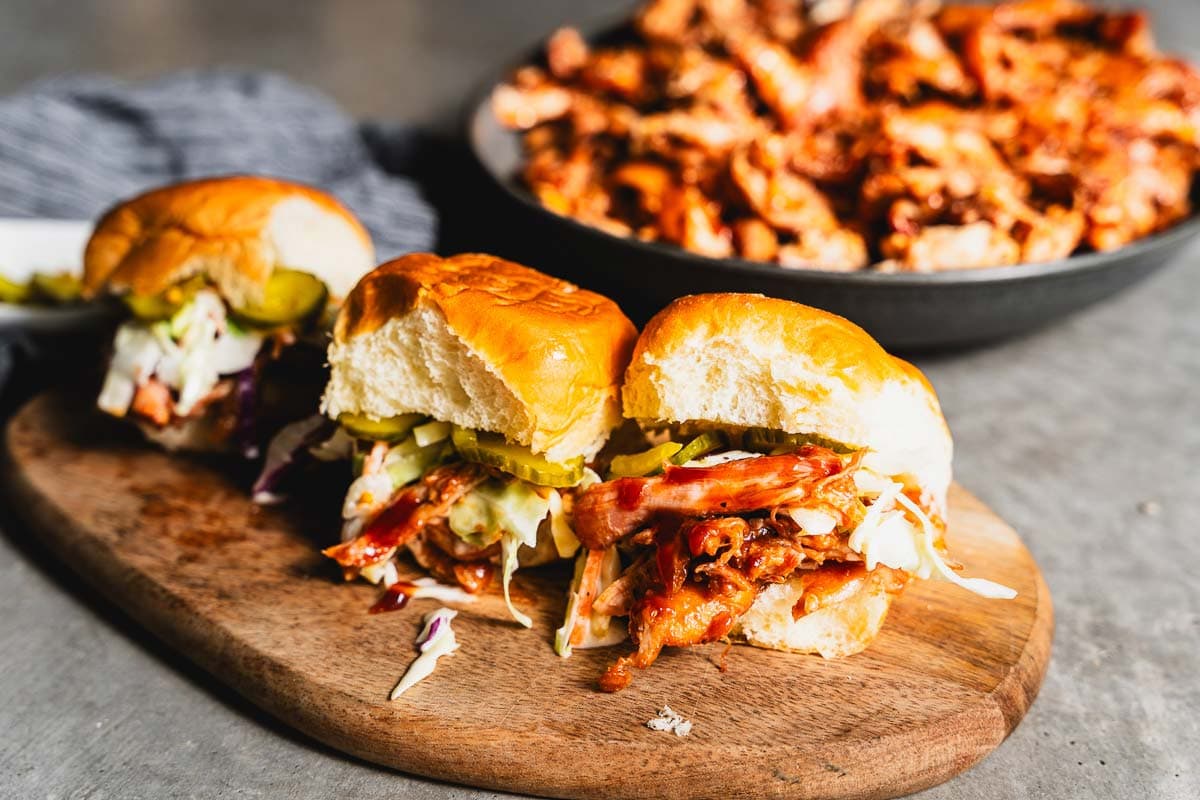 bbq chicken sliders with slaw on cutting board horizontal