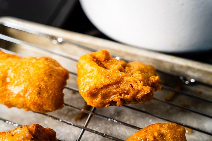 beer battered deep fried salmon on cooling rack