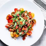 blt salad with baby arugula, heirloom tomatoes and bacon vertical
