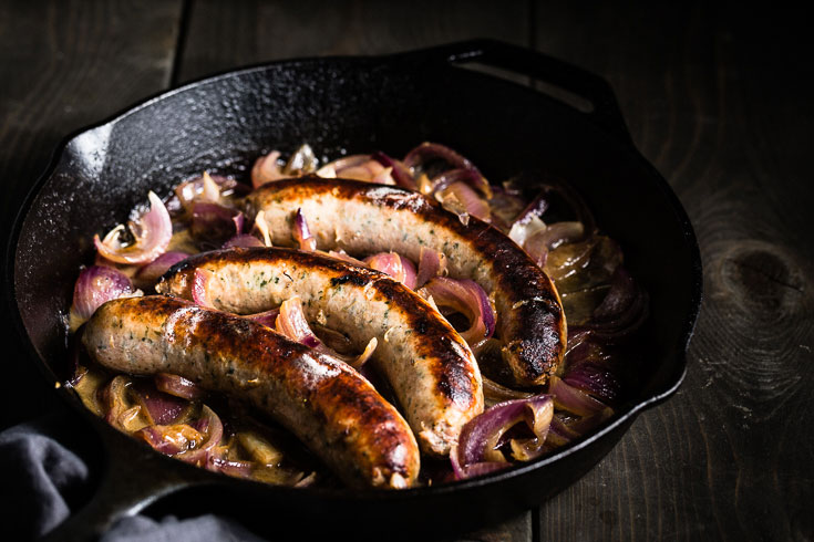 bratwurst sausage an onions skillet horizontal