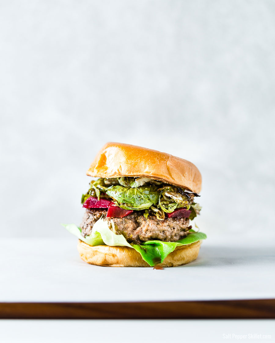 Brussels Sprouts and pickled beets burger on a brioche bun vertical