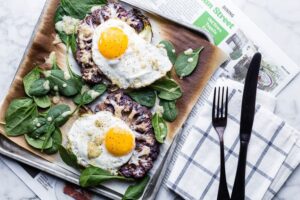 Cauliflower Veggie Toast with Fried Eggs pacesetting with newspaper