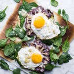 Cauliflower Veggie Toast with Fried Eggs and spinach on marble