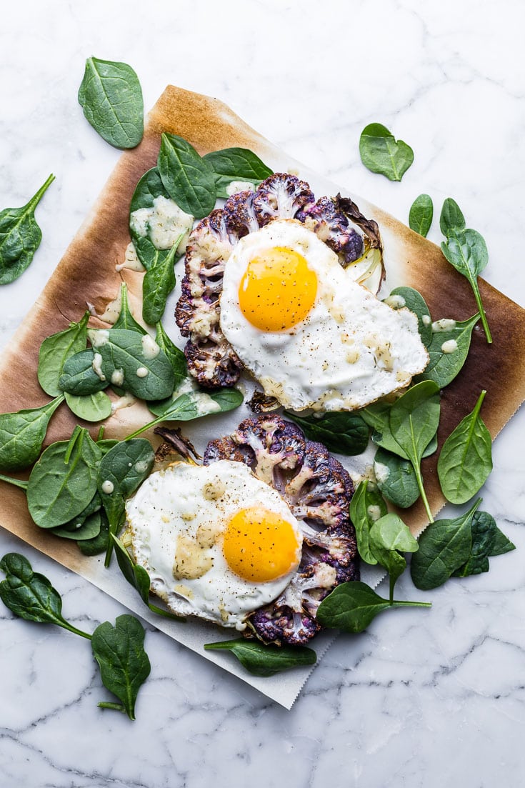 Cauliflower Veggie Toast with Fried Eggs and spinach on marble