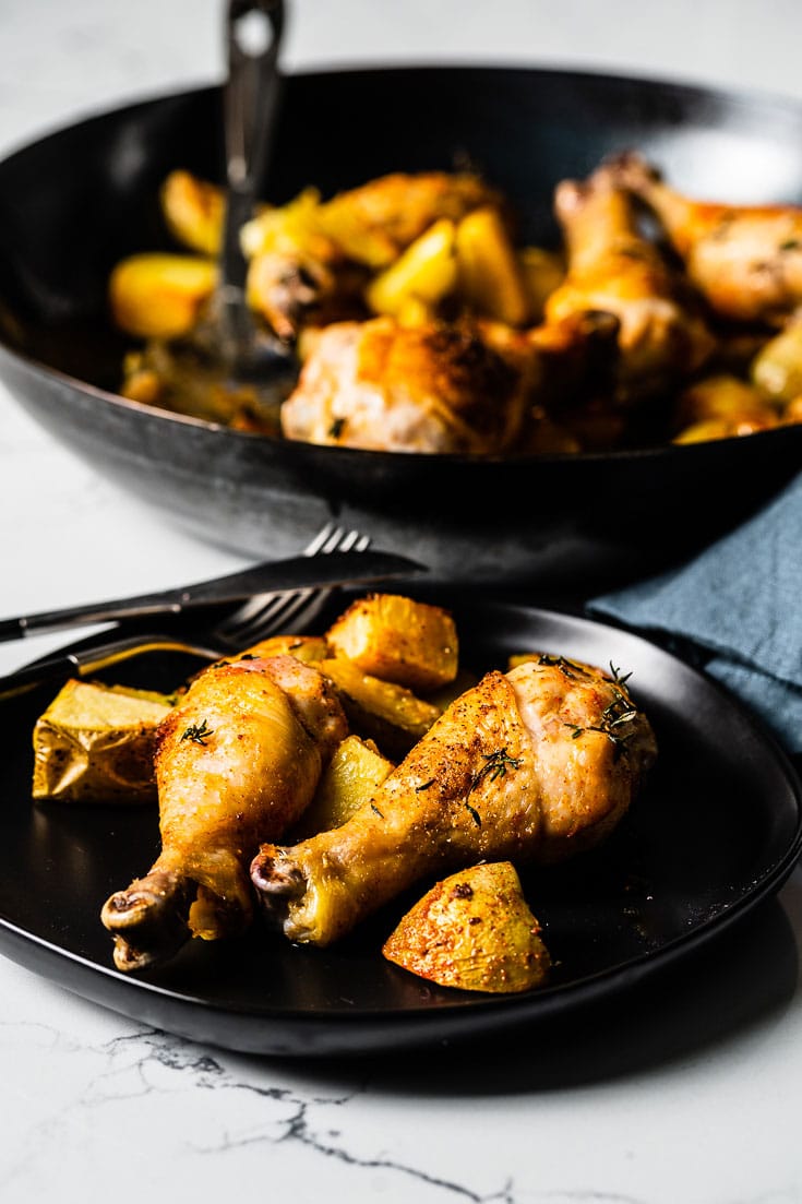 chicken drumsticks on plate with potatoes