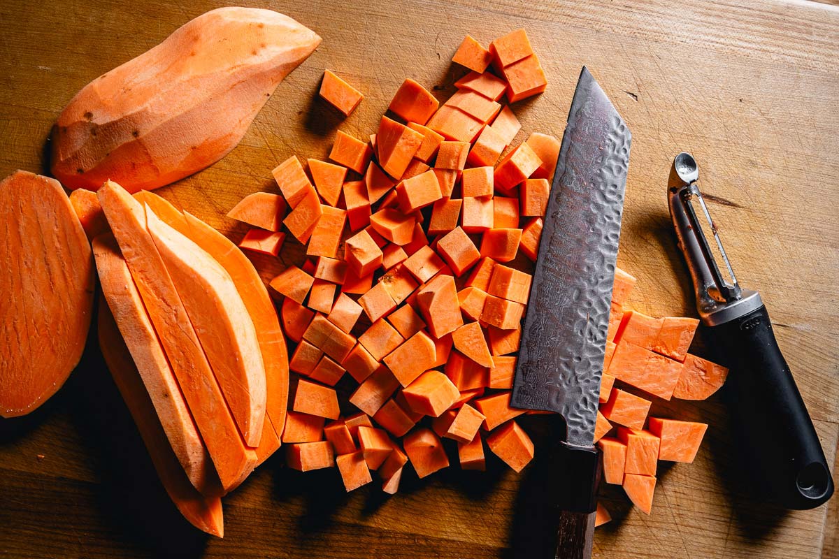 chopping sweet potatoes to roast in oven