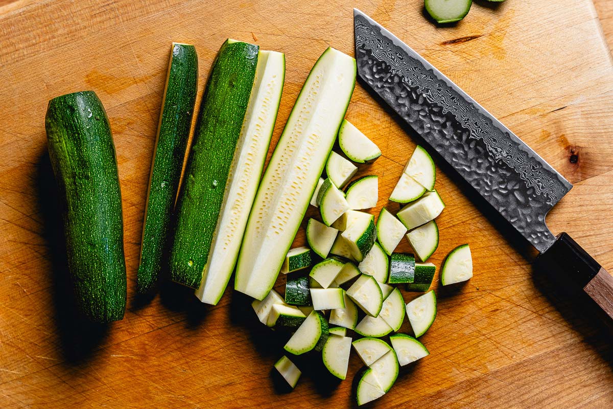 cutting zucchini into quarters