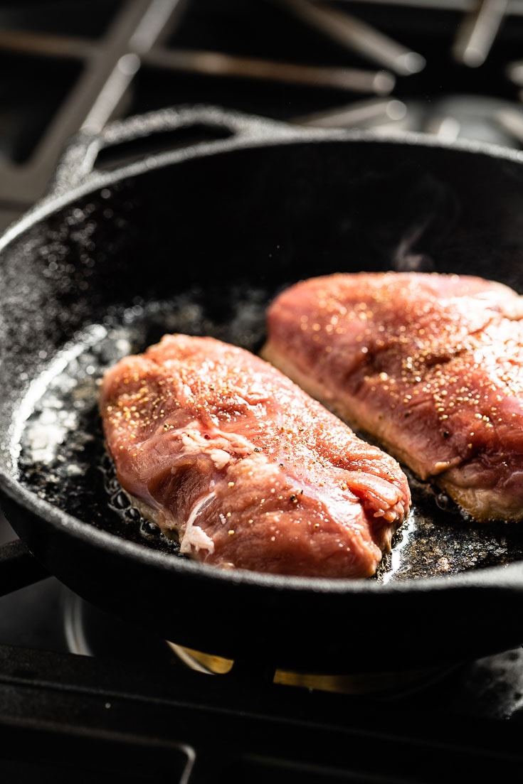 duck breasts crisping in skillet