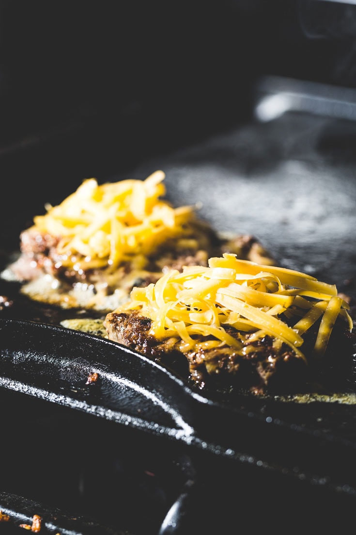 flat top cheeseburger on griddle