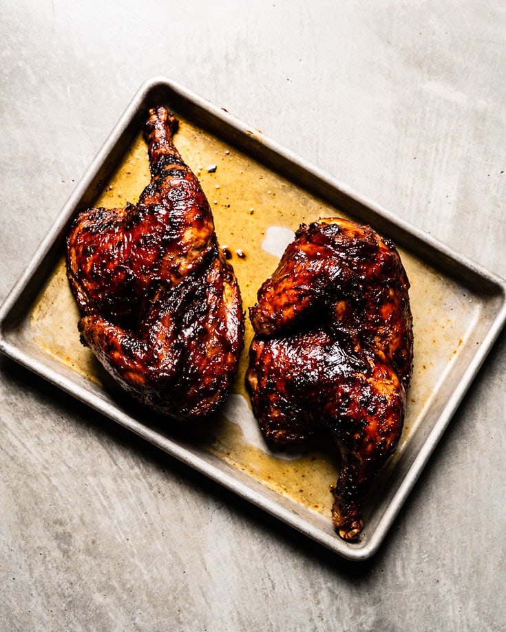 grilled bbq chicken halves on sheet pan