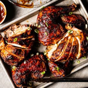 grilled bbq chicken on a sheet pan with BBQ Sauce