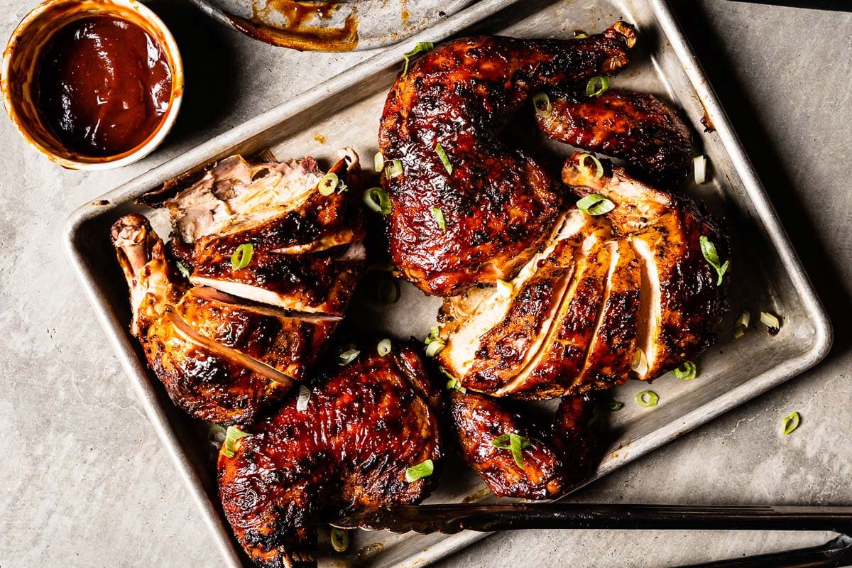grilled bbq chicken on a sheet pan with BBQ Sauce