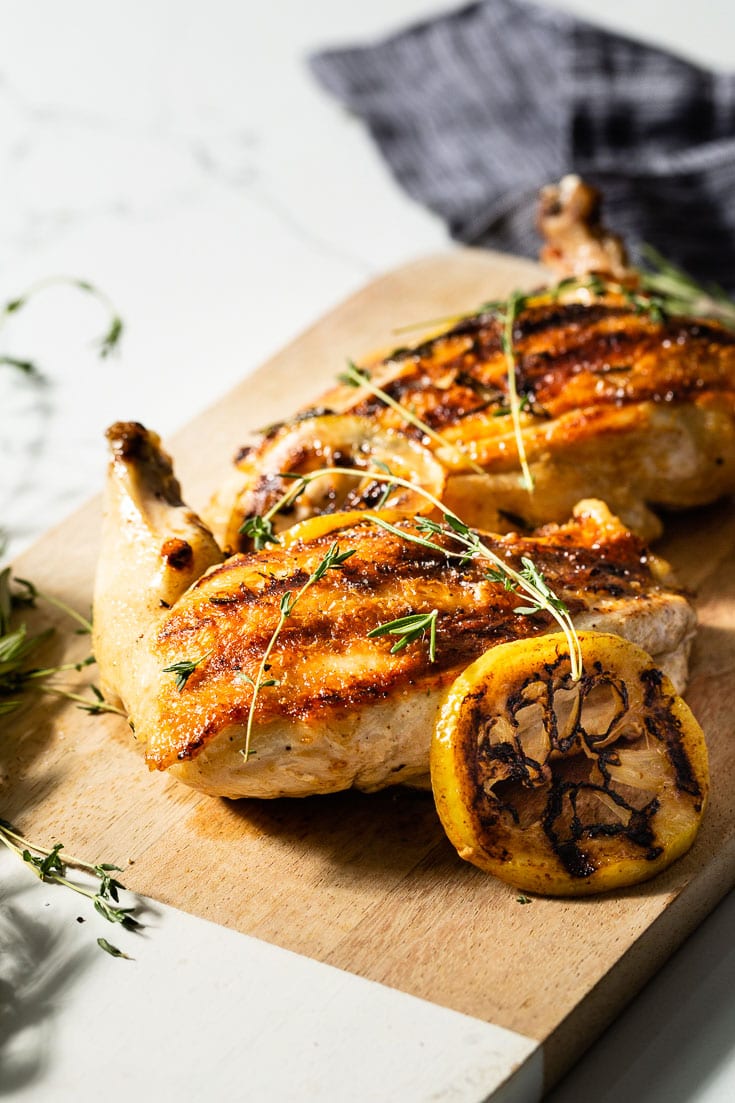 grilled chicken breast on cutting board
