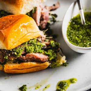 grilled lamb sliders on a plate with chimichurri