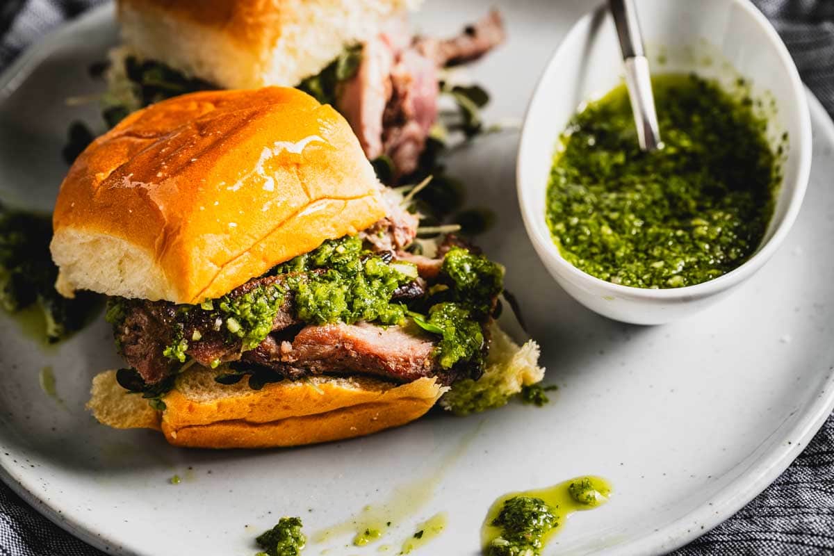 grilled lamb sliders on a plate with chimichurri