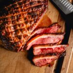 grilled picanha sliced on cutting board