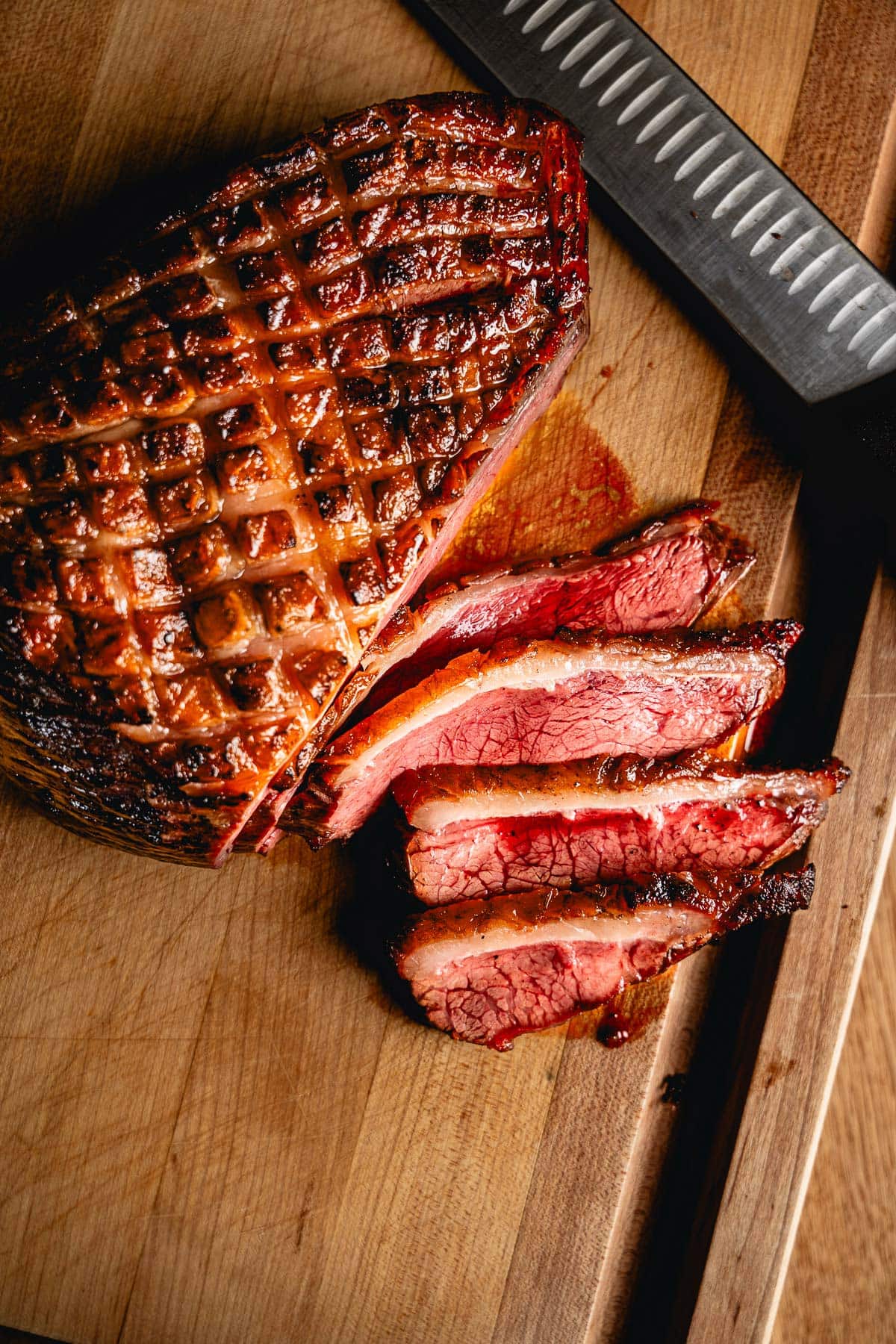 grilled picanha sliced on cutting board