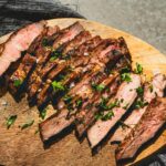 grilled pork steaks sliced on a cutting board