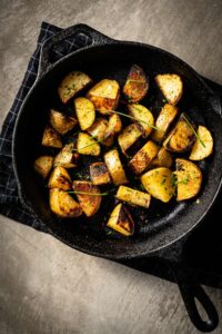 grilled potatoes in skillet vertical