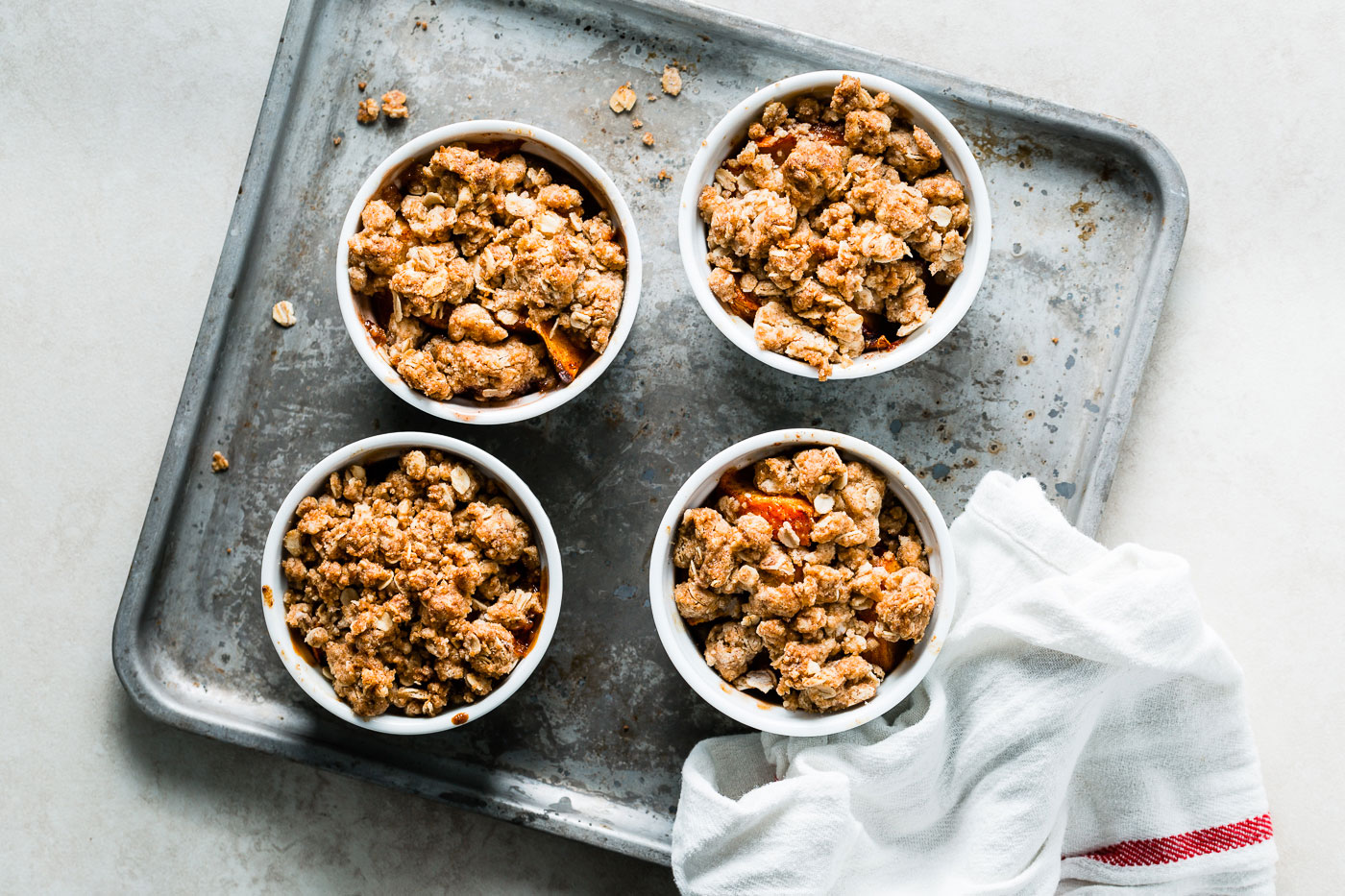 individual peach crumbles on sheet pan