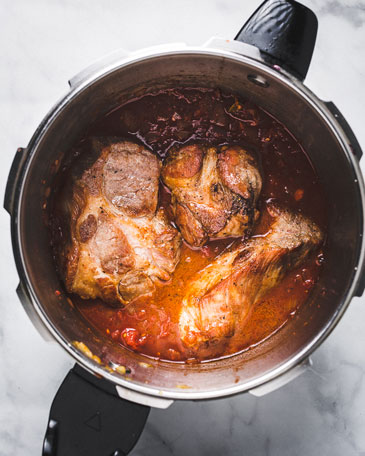 There are few dishes as comforting as pork shoulder ragu over creamy polenta on a chilly winter day. The high pressure takes all the pressure off of you. The pork is fall-apart tender after 35 minutes under high pressure. As easy and hands-off as braises can be, the time involved to make the meat tender be a deterrent to making them. That's where an Instant POt or pressure cooker makes. This pork ragu is ready in about an hour. Pretty amazing, right? Serve it with pasta or polenta. or whatever else? even in tacos, over gnocchi, risotto or rice Recipe variations: You could use bbq sauce instead of the tomatoes for bbq pulled pork. You can also switch up the protein and use beef or lamb to make ragu from those. They will all taste great and it's pretty impossible to mess up. How to make pork ragu in a pressure cooker If you are anything like me and get intimidated by long recipes, let me give it to you in the most basic way. This recipe looks a little long, but don't let that intimidate you. Here are the basic steps so you can even make it without a recipe. Don't have an Instant Pot or a Pressure Cooker? Well, obviously you should order one right now. But if you want to make it before it arrives, then you are in luck. You can follow the same steps and use a dutch oven instead. It will take about ___ hours instead of 35 minutes. Special Equipment Used Instant Pot or a Pressure CookerLadleCutting boardkitchen twine