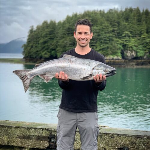 justin mcchesney holding a copper river king salmon