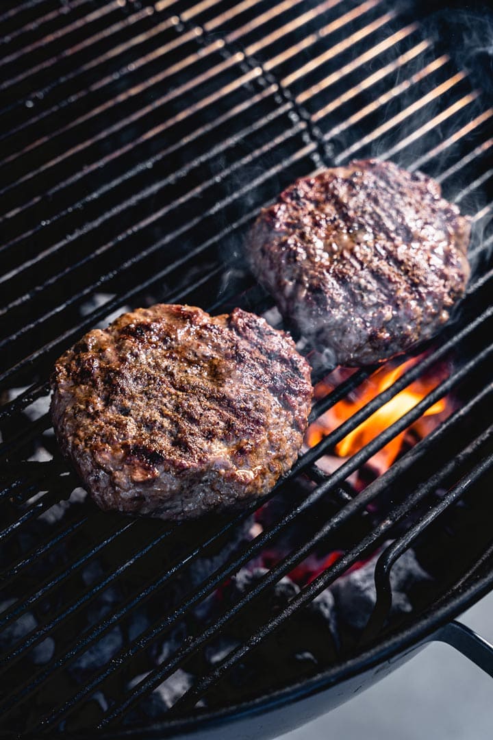 lamb burgers on the grill flipped