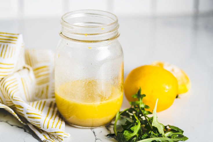 lemon vinaigrette in mason jar with arugula 3