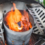lit Kingsford Charcoal briquets in chimney starter