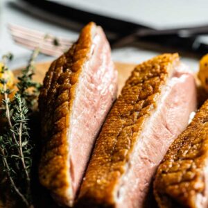 pan seared duck breasts on cutting board