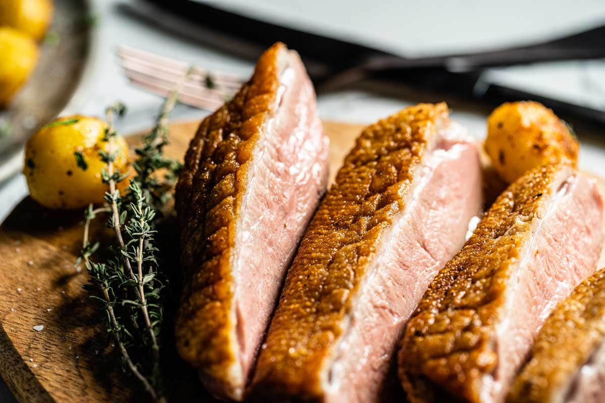 pan seared duck breasts on cutting board