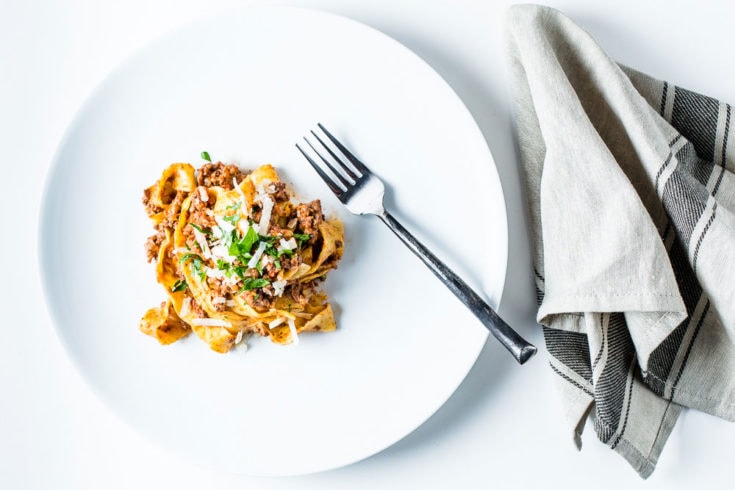 Pasta Bolognese Overhead with fork and napkin