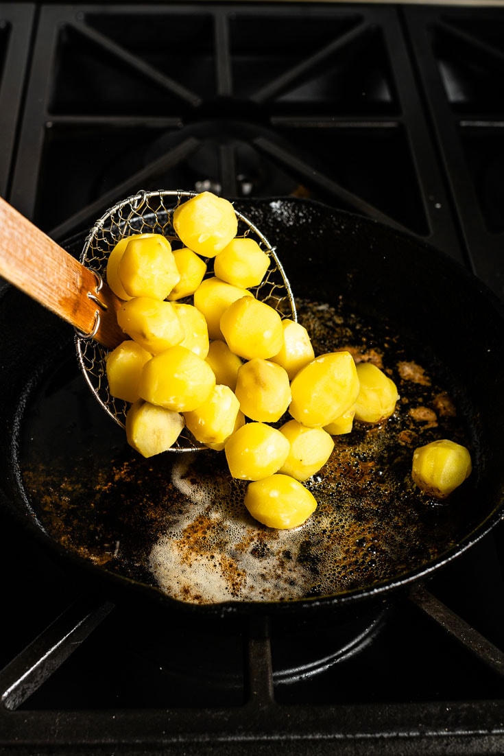 potatoes going into duck fat skillet