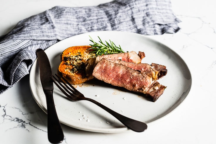 reverse seared steak with roasted sweet potato on plate