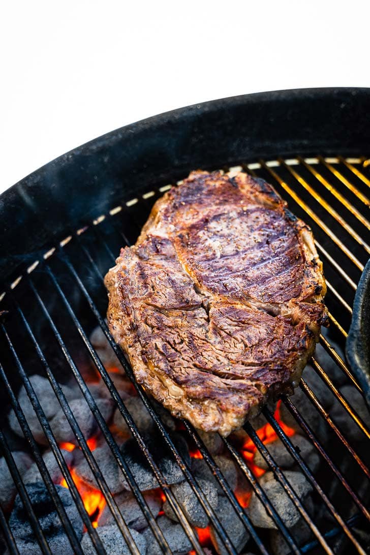 rib eye steak on charcoal grill