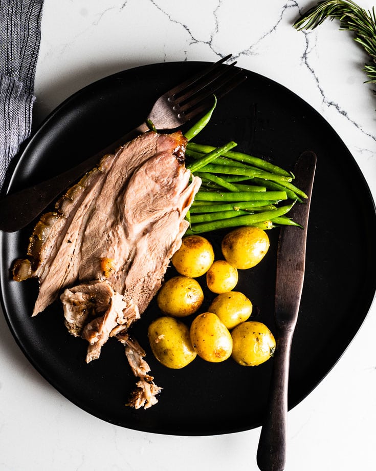 roast pork shoulder with potatoes and green beans