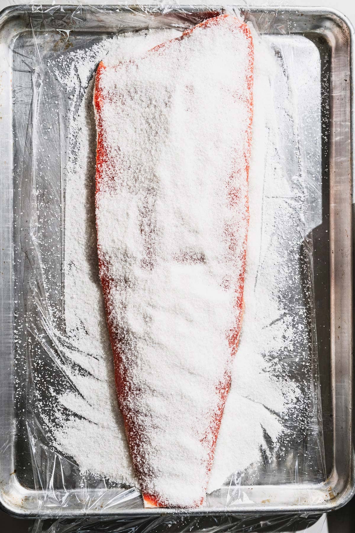 salmon filet on sheet pan for cold smoking with brine