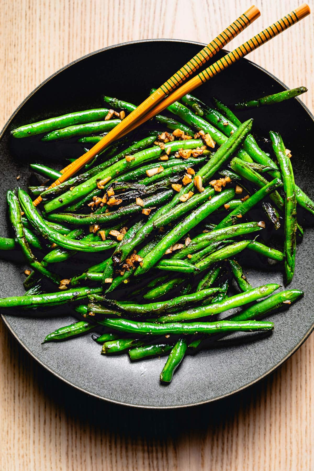 sauteed green beans with garlic on plate overhead