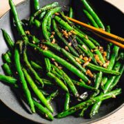 sauteed green beans with garlic on plate side view