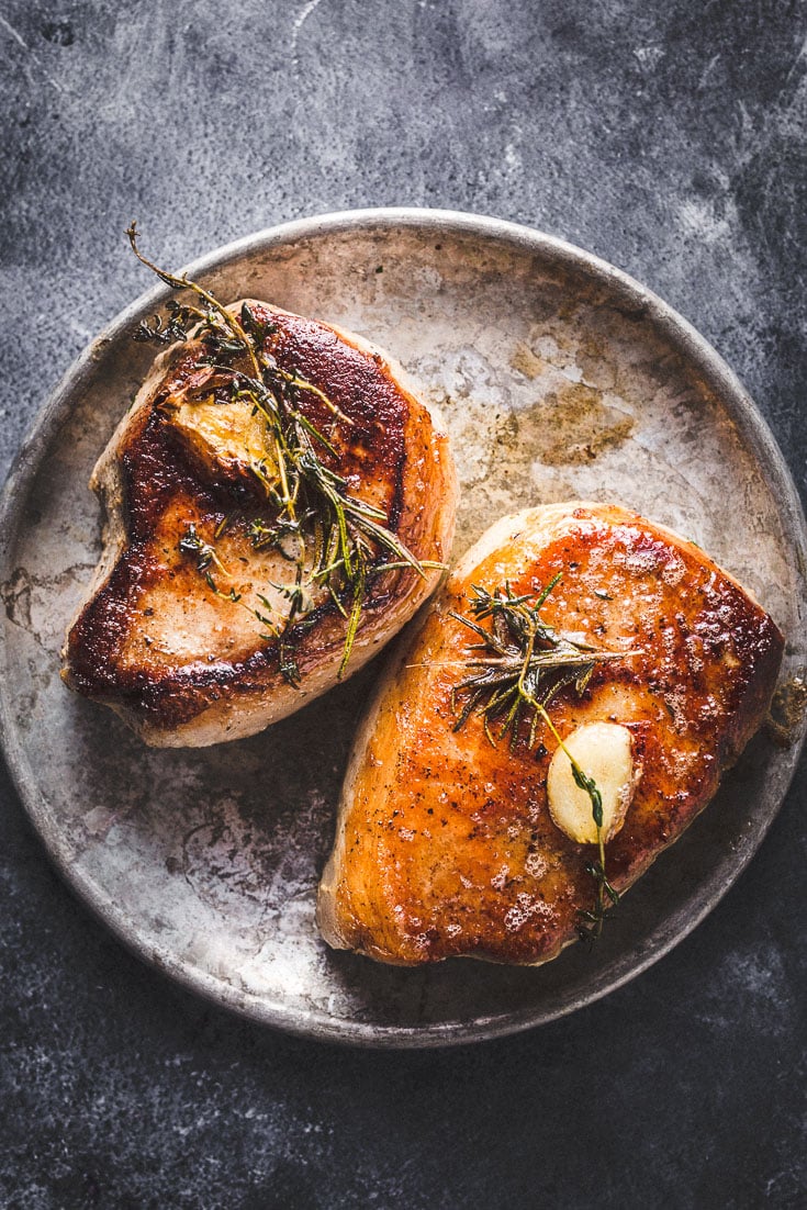 seared sous vide pork chops on metal plate